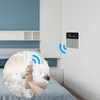 A person in bed using a smartphone to control a smart thermostat on the wall. Podgląd zdjęcia produktu