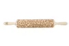 A wooden rolling pin with an engraved floral pattern, shown against a white background. Produktbild-Vorschau