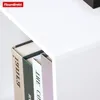 A close-up view of books on a white shelf. Náhled obrázku produktu