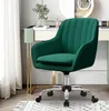 A green velvet office chair is shown in a well-lit room, possibly a home office or dressing area, with a vanity table and curtains in the background. Produktbild-Vorschau