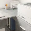 A close-up view of a desk with office supplies and a printer. Produktbild-Vorschau