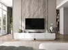 A modern living room with a TV stand and a large TV mounted on a stone-textured wall. Produktbild-Vorschau