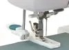 Close-up of a sewing machine foot and a button attachment. Produktbild-Vorschau