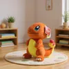 A plush toy of Charmander from Pokemon is sitting on a rug in a room with shelves and plants. Produktbild-Vorschau
