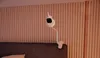A white flexible camera mount is attached to the headboard of a bed, with the camera facing forward. Anteprima dell’immagine prodotto
