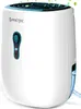 A white dehumidifier with a blue accent and a visible water tank with blue water. Náhled obrázku produktu