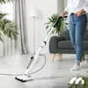 A person is using a white steam cleaner on a light-colored floor in a living room setting. Produktbild-Vorschau