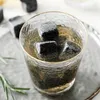 A close-up shot of whiskey stones in a glass of drink. Produktbild-Vorschau
