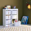 A child's storage unit with toys and books in a room. Produktbild-Vorschau