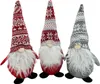 Three Christmas gnomes with knitted hats and white beards are standing against a white background. Náhľad obrázku produktu