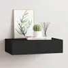 A black floating shelf mounted on a white wall, decorated with a framed print of olive branches, a small potted cactus, and a reed diffuser. Produktbild-Vorschau