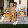 A couple sits on a garden bench outdoors. Náhled obrázku produktu