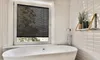 A bathroom scene with a bathtub and a window with blinds. Produktbild-Vorschau