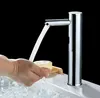 A person is washing their hands under a modern, sensor-activated faucet in a bathroom sink. Podgląd zdjęcia produktu