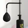 A close-up view of a black punching bag attached to a stand. Voir les images du produit
