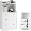A white wooden dresser with three drawers and an open shelf above, shown next to a smaller, identical dresser unit. The larger dresser has decorative items on the top shelf and in the open compartment. Náhled obrázku produktu