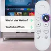 A white remote control for a Google Chromecast is shown in front of a television screen displaying a menu. A pop-up window shows voice command suggestions. Produktbild-Vorschau