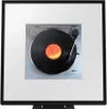 A framed image of a turntable with a vinyl record playing. Náhled obrázku produktu