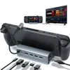 A Steam Deck gaming console is docked to a hub, which is connected to a TV displaying a game library. Produktbild-Vorschau