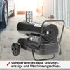 A black diesel heater with a silver exhaust pipe is shown in an outdoor setting, possibly a garage or driveway, next to a car. Produktbild-Vorschau