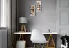 A home office desk setup with a white chair, a lamp, and framed photos on the wall. Náhľad obrázku produktu