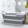 A foldable pet bathtub is shown in a room, with icons above indicating its various uses. Produktbild-Vorschau