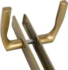 A close-up view of two gold-colored door handles connected by a metal rod. Anteprima dell’immagine prodotto