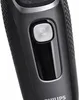A close-up shot of a black electric shaver, focusing on the power button. Produktbild-Vorschau