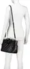 A black quilted handbag is shown from the back on a white mannequin. Náhľad obrázku produktu