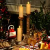 A festive table setting with Christmas decorations, including a Christmas tree, candles, champagne glasses, bread, and cheese. Voir les images du produit