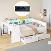A white bed with integrated desk and storage, featuring LED lighting and a close-up inset of a power outlet with USB ports. Podgląd zdjęcia produktu