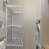A laundry room with a wall-mounted drying rack and stacked washing machines. Produktbild-Vorschau