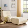 A beige beanbag chair and ottoman are placed on a wooden floor in a living room setting, next to a window with curtains. Náhled obrázku produktu