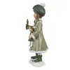 A decorative figurine of a girl holding a doll and a candle. Voir les images du produit
