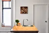 A kitchen scene with a clock on the wall above a sink and countertop. Produktbild-Vorschau