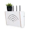 A white router stand with a plant on top, mounted on a white wall. Anteprima dell’immagine prodotto