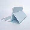 A light blue tablet case with an integrated keyboard is shown in a studio setting against a white and light gray background. Náhled obrázku produktu