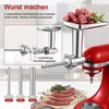 A close-up view of a red KitchenAid stand mixer attachment for grinding meat and making sausages, with various components and finished sausages displayed. Produktbild-Vorschau