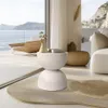 A modern living room with a view of the ocean, featuring a stylish side table. Podgląd zdjęcia produktu