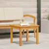 A wooden side table with a book and glasses on it, placed on a patio next to a sofa. Voir les images du produit