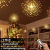 A decorated Christmas tree with starburst lights hanging from the ceiling and on shelves. Náhled obrázku produktu