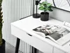 A close-up view of a white desk with a magazine open on it, a small potted plant, and a desk lamp. Voir les images du produit