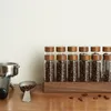 Coffee beans in storage containers on a wooden surface. Produktbild-Vorschau