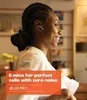 A woman wearing earbuds in a home setting. Produktbild-Vorschau