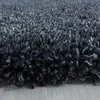 A close-up view of a dark gray, high-pile rug. Produktbild-Vorschau