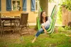 A woman relaxing in a hammock in a garden setting. Náhled obrázku produktu
