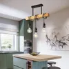 A modern kitchen with a wooden island and a pendant light fixture. Náhľad obrázku produktu
