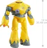 A yellow robot toy standing against a white background, with a ruler indicating its height on the right side. Produktbild-Vorschau