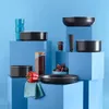 A collection of cookware and kitchen items arranged on blue blocks against a blue background. Voir les images du produit