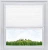 A white pleated blind is shown partially covering a window, revealing a view of a green forest and sky. Produktbild-Vorschau